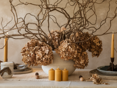 seasonal table centerpiece using branches, dried hydrangea, and beeswax candles